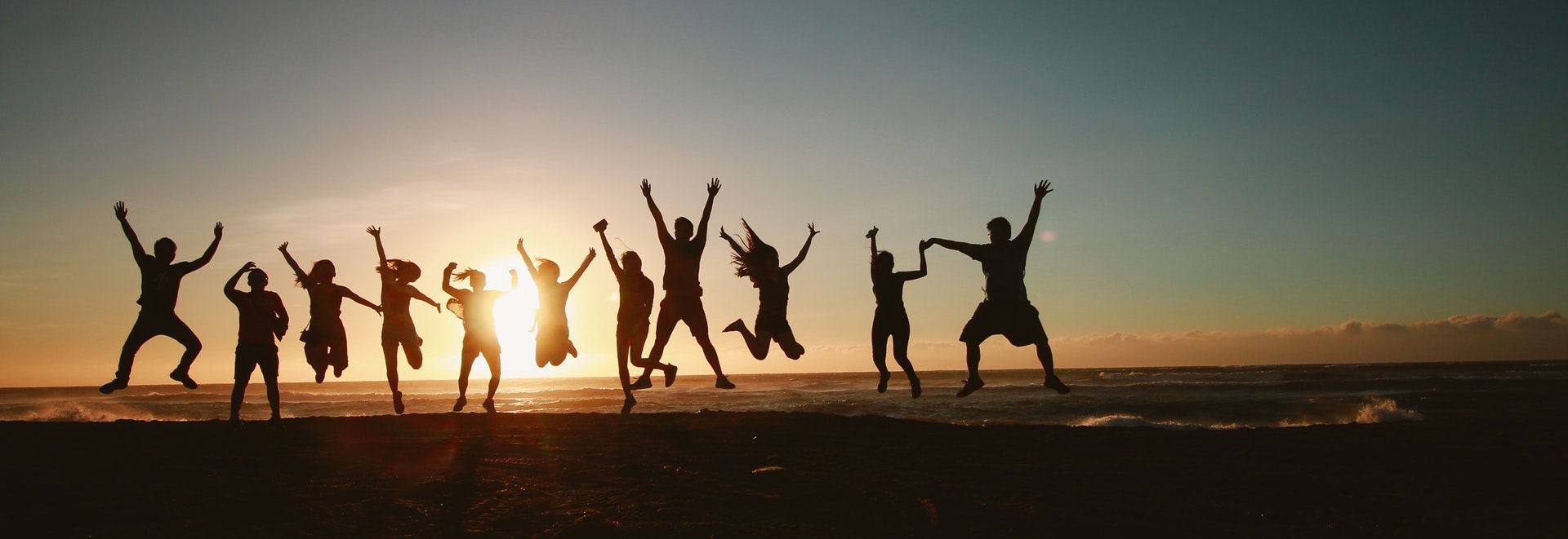 people jumping with sunset background